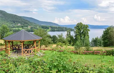 a gazebo in a field next to a lake at Bjertnes Turistgård in Noresund