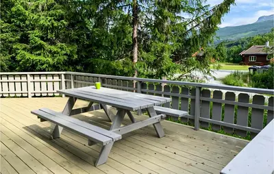 a picnic table and bench on a wooden deck at Stunning Apartment In Hemsedal in Hemsedal