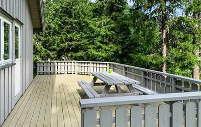 a wooden deck with a picnic table on a house at Stunning Apartment In Hemsedal in Hemsedal