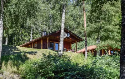 a house on a hill in the woods at Bjertnes Turistgård in Noresund