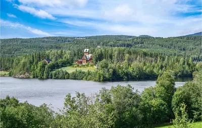 a house on an island in the middle of a river at Bjertnes Turistgård in Noresund