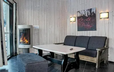 a living room with a couch and a fireplace at Cozy Apartment In Hemsedal With Sauna in Hemsedal