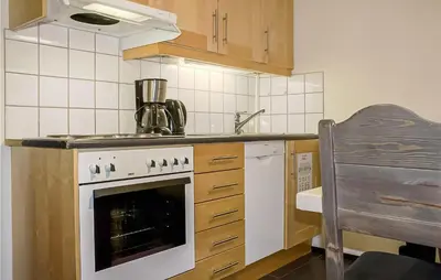 a kitchen with a white stove top oven next to a sink at Cozy Apartment In Hemsedal With Sauna in Hemsedal