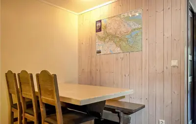 a table and chairs with a map on the wall at Cozy Apartment In Hemsedal With Sauna in Hemsedal