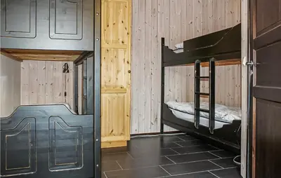 a room with two bunk beds and a door at Cozy Apartment In Hemsedal With Sauna in Hemsedal