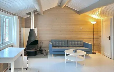 a living room with a blue couch and a table at 4 Bedroom Lovely Home In Ål in Ål