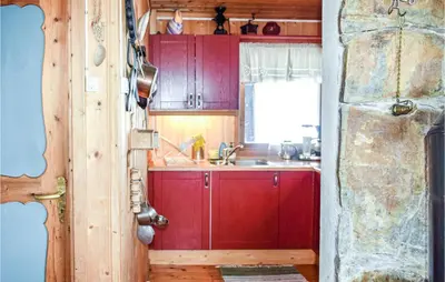 a kitchen with red cabinets and a sink at 2 Bedroom Beautiful Home In Gol in Gol