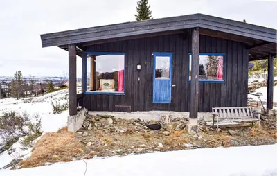 a small cabin with a bench in the snow at 2 Bedroom Beautiful Home In Gol in Gol