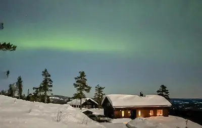a cabin with the aurora in the sky at Awesome Home In Hønefoss With Wifi in Hønefoss