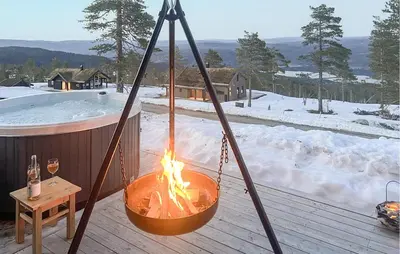 a fire pit on a deck next to a hot tub at Awesome Home In Hønefoss With Wifi in Hønefoss