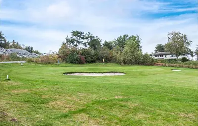 a view of the green at a golf course at Stunning Home In Frosta