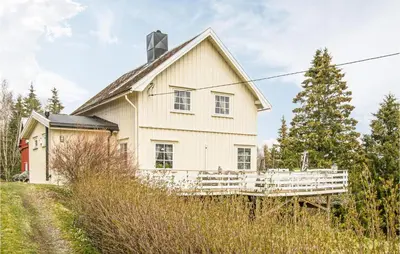 a white house with a fence in front of it at Amazing Home In Ytterøy With Wifi