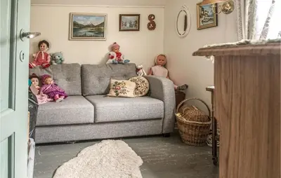 a group of children sitting on a couch in a living room at Amazing Home In Ytterøy With Wifi