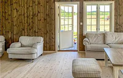 a living room with a couch and chairs and a table at Nice Home In Beitstad With Kitchen in Sunnan