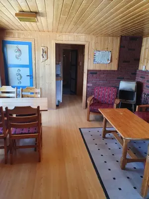 a living room with a table and chairs at Bjørklund in Geilo