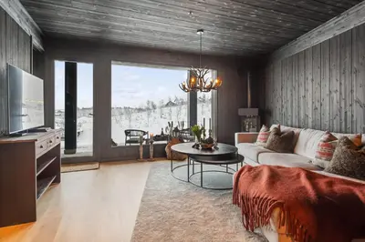 a living room with a couch and a table at Kikut Alpine Lodge 9103 in Geilo