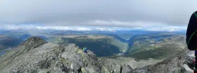 a person standing on the top of a mountain at Gaustatoppen Lodge - Mountain View - Gaustablikk in Rjukan