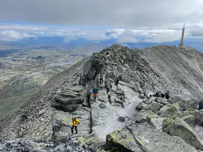 a group of people on the summit of a mountain at Gaustatoppen Lodge - Mountain View - Gaustablikk in Rjukan