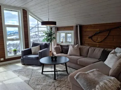 a living room with a couch and a table at Fosskamben Panorama Sogndal in Sogndal