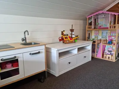 a childs kitchen with a sink and a toy truck on a counter at Fosskamben Panorama Sogndal in Sogndal