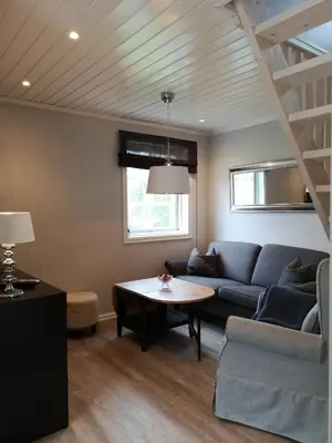 a living room with a couch and a table at Fosskamben Panorama Sogndal in Sogndal