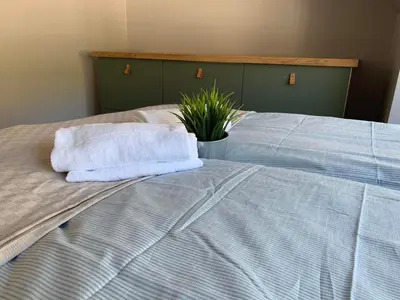 a bed with two towels on it with a plant on it at Trolltunga Panorama in Tysso
