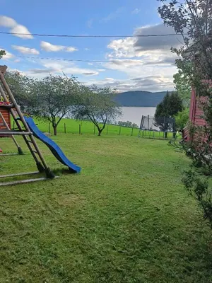 a playground with a blue slide in a park at Randsfjord house in Gran
