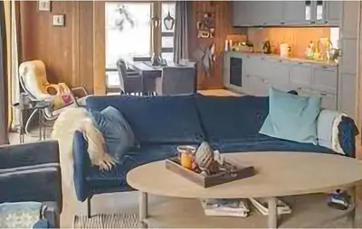 a living room with a blue couch and a table at 4 Bedroom Beautiful Home In Rjukan in Rjukan