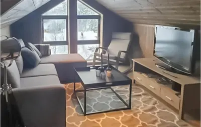 a living room with a couch and a tv at 4 Bedroom Beautiful Home In Rjukan in Rjukan