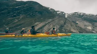 a group of people in a yellow kayak in the water at Skjolden Resort in Skjolden