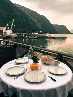 a table with plates of food on top of a boat at Skjolden Resort in Skjolden