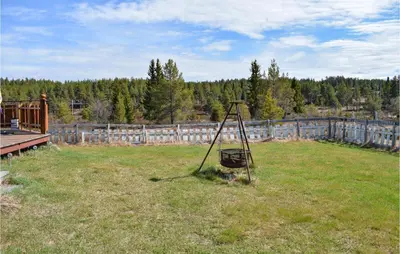 a basket in the middle of a field of grass at Amazing Home In Tisleidalen With Sauna in Hovda