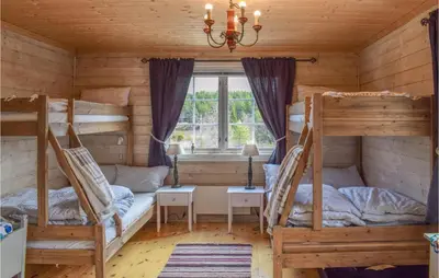 a bedroom with two bunk beds and a window at Amazing Home In Tisleidalen With Sauna in Hovda