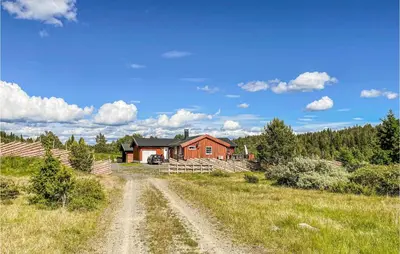 a dirt road in front of a red house at Amazing Home In Tisleidalen With Sauna in Hovda