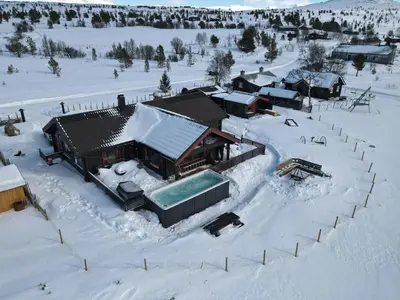 an aerial view of a house covered in snow at Trollvang, hytte med pool og sauna in Dovreskogen