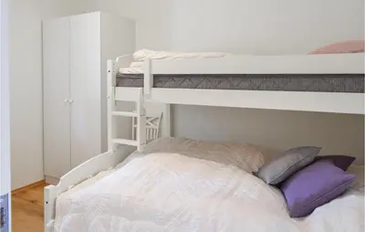 a bedroom with two bunk beds with purple pillows at Fjellheimen Nr 104 in Sjusjøen