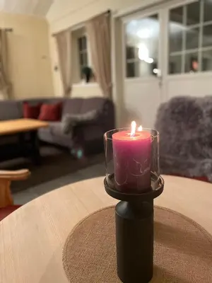 a candle sitting on a table in a living room at Hytte i nydelige Jotunhemen - rett ved Besseggen in Randsverk