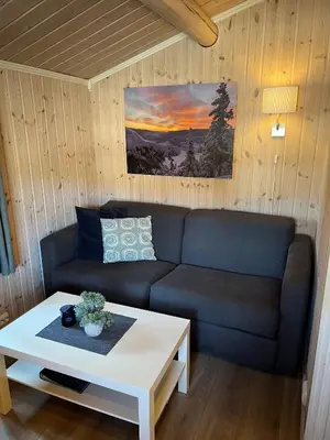 a living room with a couch and a coffee table at Fagernes Camping in Fagernes