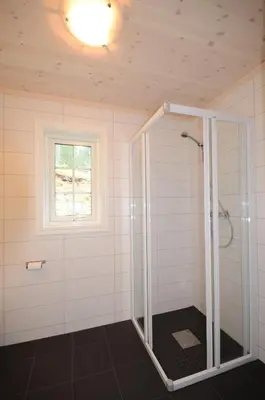 a bathroom with a shower with a window at Fagernes Camping in Fagernes