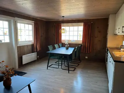 a kitchen and dining room with a table and chairs at Fagernes Camping in Fagernes