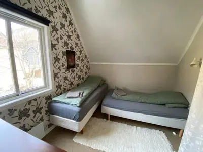 a bedroom with two beds and a window at Tveitopark Apartments A in Rjukan
