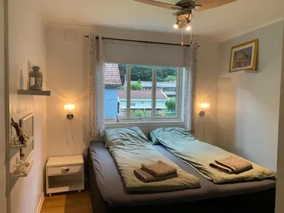 a bed in a room with a window at Tveitopark Apartments A in Rjukan