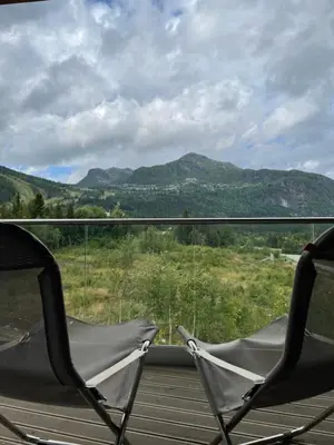 two chairs on a porch with a view of mountains at Snøya Lodge in Hemsedal