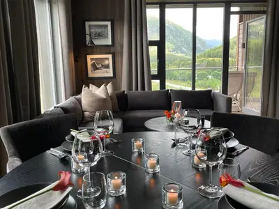 a dining room with a table with wine glasses on it at Snøya Lodge in Hemsedal