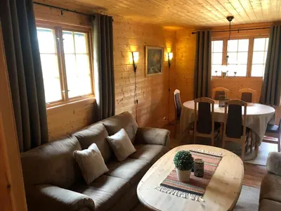 a living room with a couch and a table at Solvang World Heritage Camping in Eidsdal