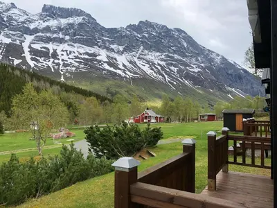 a view of a snow covered mountain from a porch at Solvang World Heritage Camping in Eidsdal