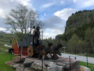 a statue of two people standing on a tractor at Solvang World Heritage Camping in Eidsdal