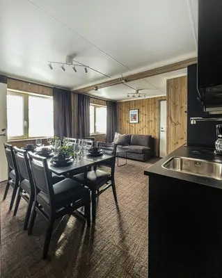 a kitchen and dining room with a table and chairs at Lisletun in Hovden