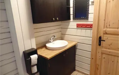 a small bathroom with a sink and a mirror at Bergheim in Vikersund