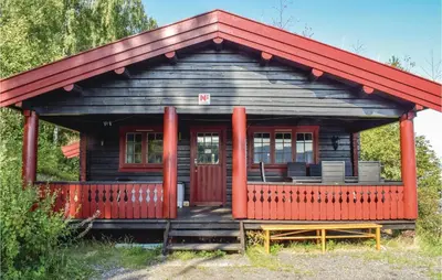 a small wooden cabin with a red roof at Bergheim in Vikersund
